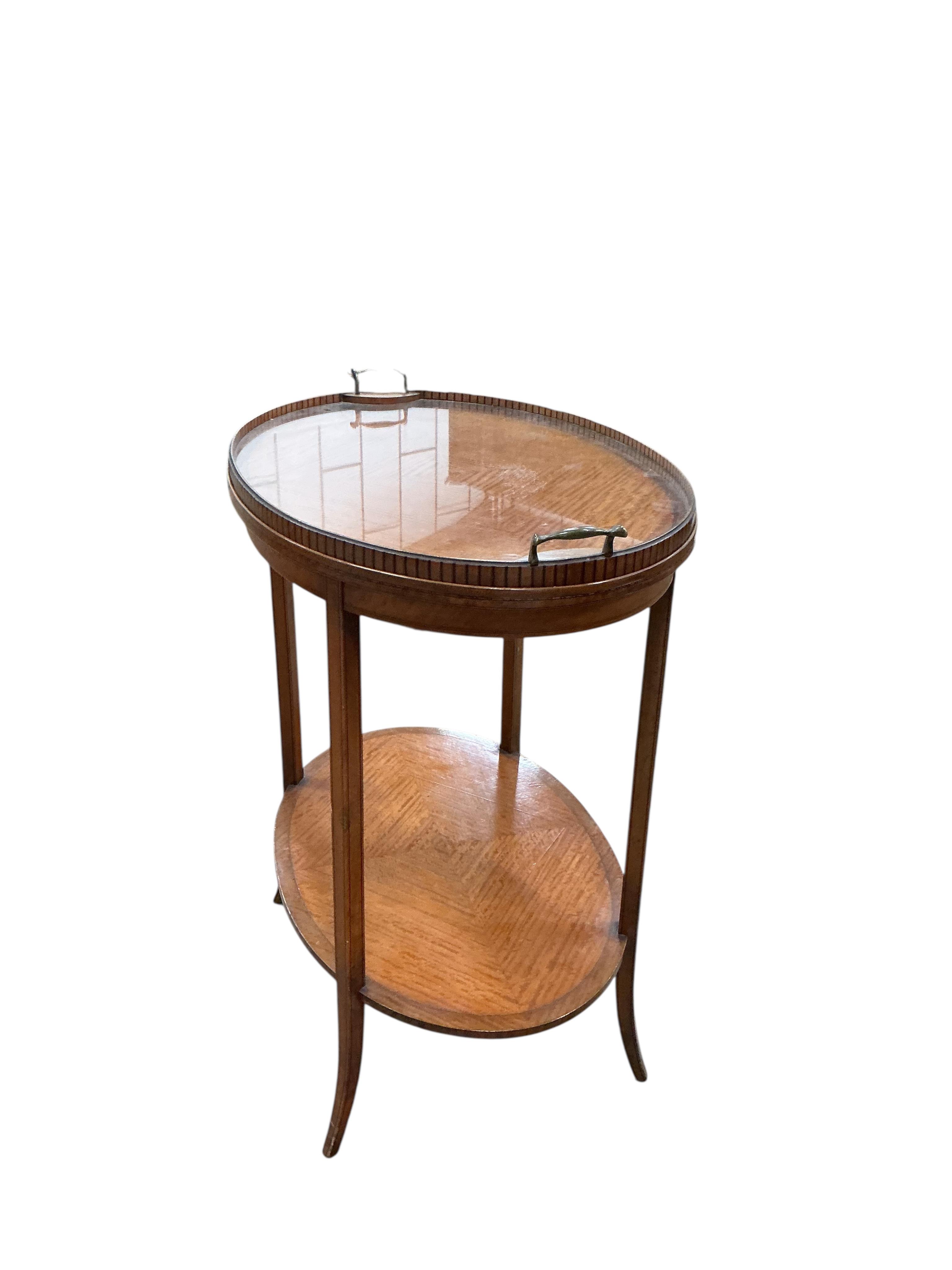 An Edwardian oval satinwood tray top etagere, width 67cm, depth 45cm, height 75cm